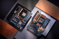 Two ROG Crosshair motherboards laid flat on a table and viewed from an overhead angle