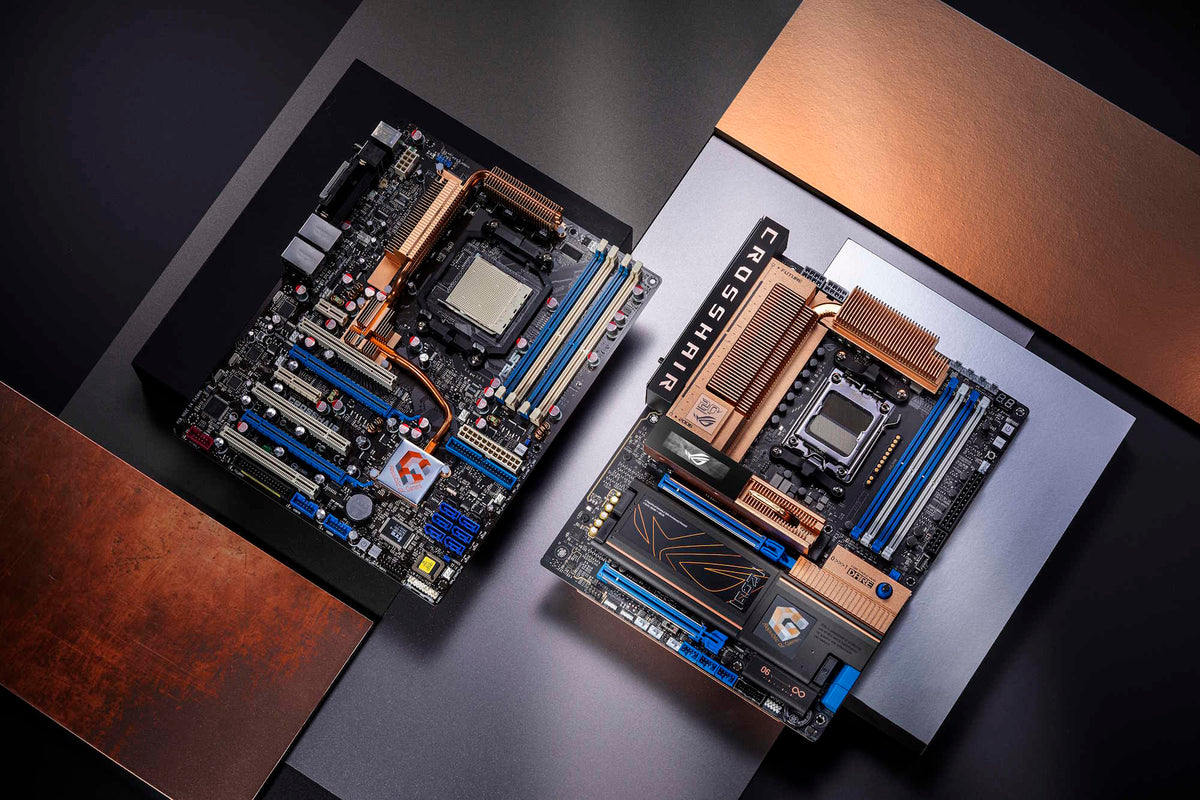Two ROG Crosshair motherboards laid flat on a table and viewed from an overhead angle