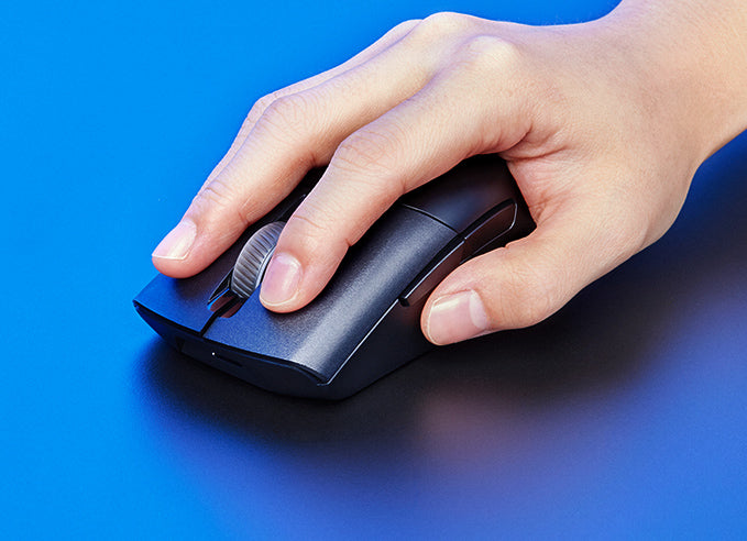 A hand clicking on the ROG Keris Wireless AimPoint