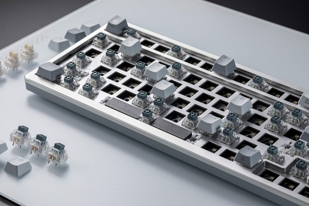 A close up view of ROG Azoth Moonlight White with most key switches removed.