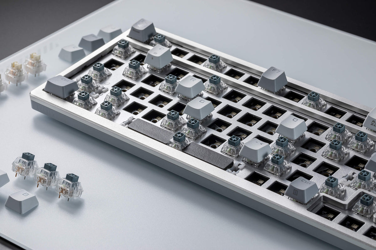 A close up view of ROG Azoth Moonlight White with most key switches removed.