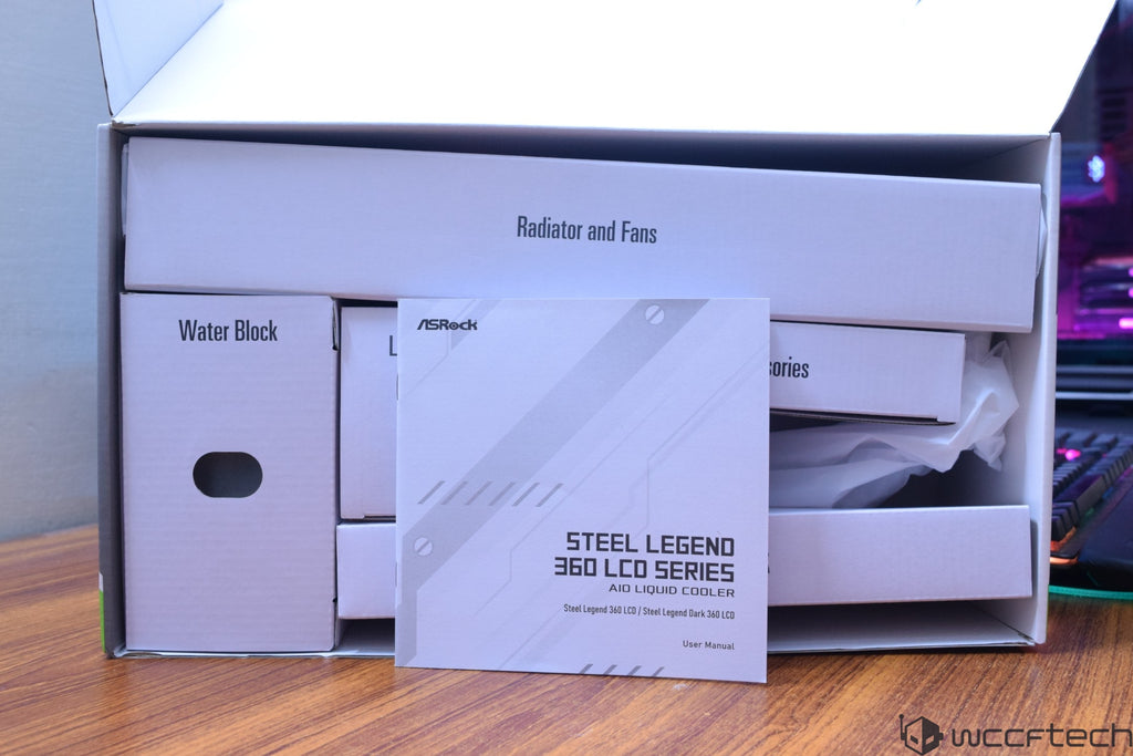 An ASRock Steel Legend 360 LCD Series AIO Liquid Cooler box with components labeled 