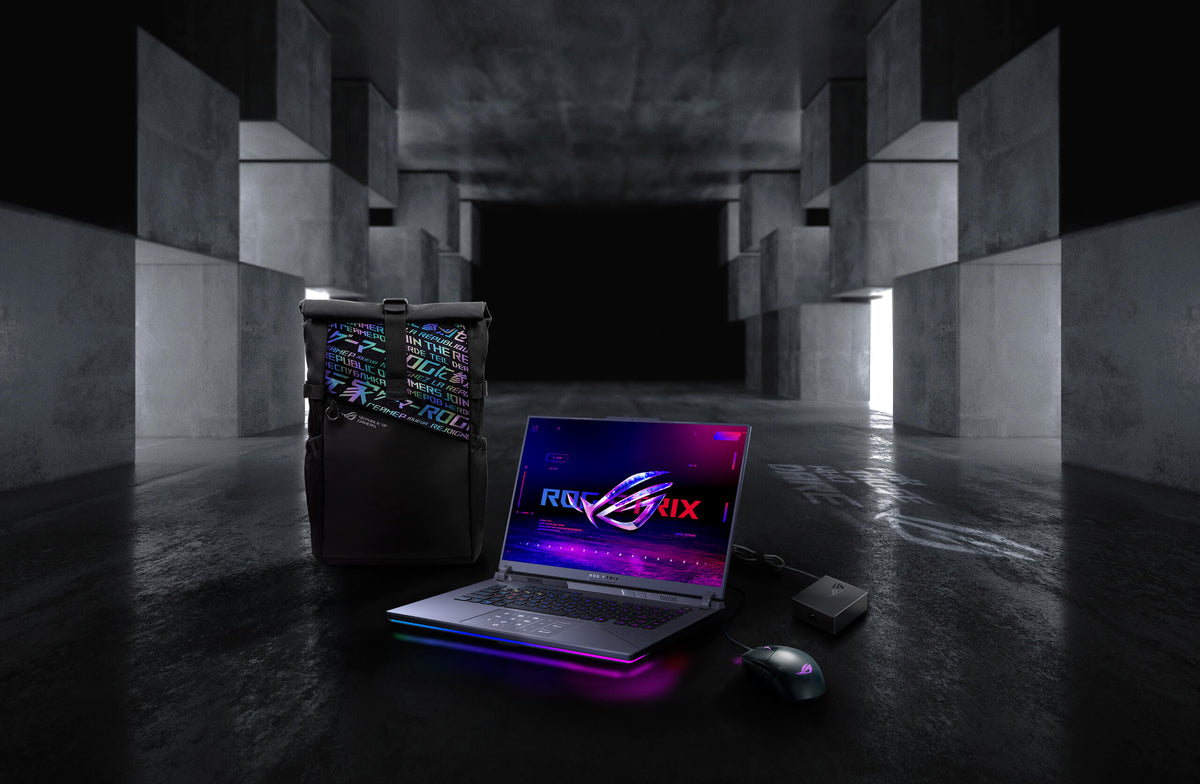 In an underground big space, from left to right; an ROG backpack, G16, ROG Strix Gladius III mouse, and 100W adapter.