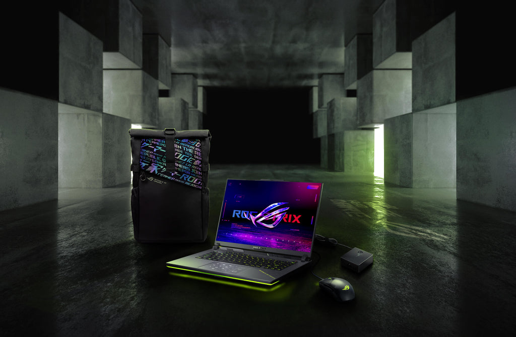 In an underground big space, from left to right; an ROG backpack, G16, ROG Strix Gladius III mouse, and 100W adapter.