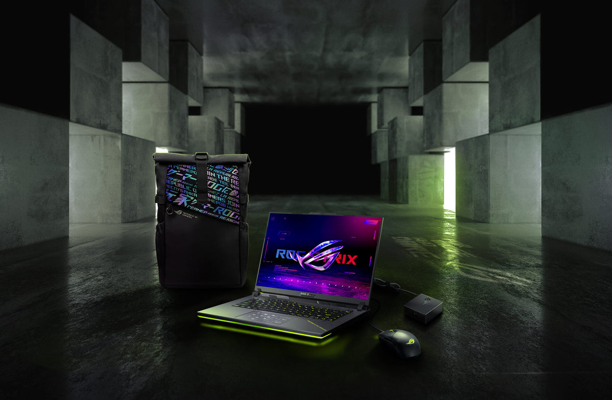 In an underground big space, from left to right; an ROG backpack, G16, ROG Strix Gladius III mouse, and 100W adapter.