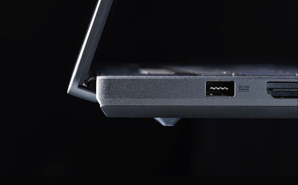 An extreme close-up of the power port and the stealth hinge design of an Eclipse Grey Zephyrus G14.