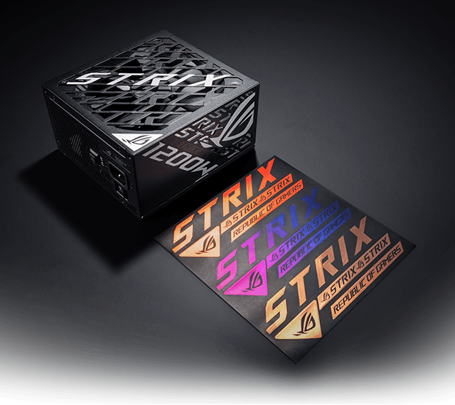 A black ROG Strix 1200W power supply shown at an angle on a dark background, with three colorful Strix logo stickers placed beside it.