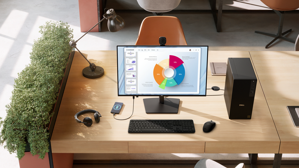A Dell Pro 27 Plus monitor on a desk, along with accessories like a wireless mouse, keyboard, headphones, and more.