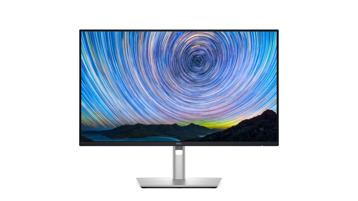 The Dell Pro 24 Plus QHD USB-C Hub Monitor with a screenfill showing mountains and a swirling starry sky.