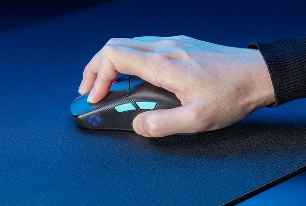 A hand gripping firmly onto a mouse, and pressing into the surface of the ROG Hone Ace XXL