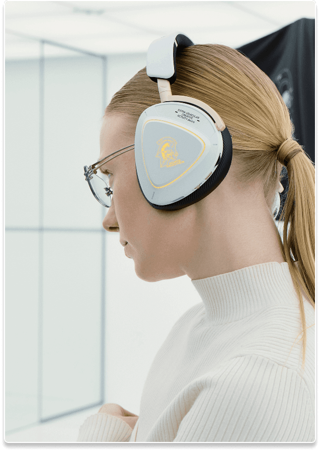 A side profile close shot of a woman in white wearing the Delta II KJP headset