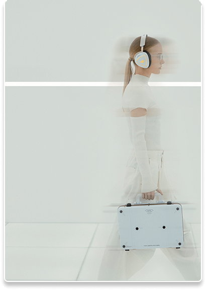 A woman in white walking in a motion blur, wearing the Delta II KJP headset and holding the Flow Z13 case
