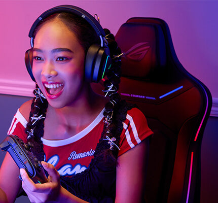 Woman playing video games while seated on the ROG Courser gaming chair