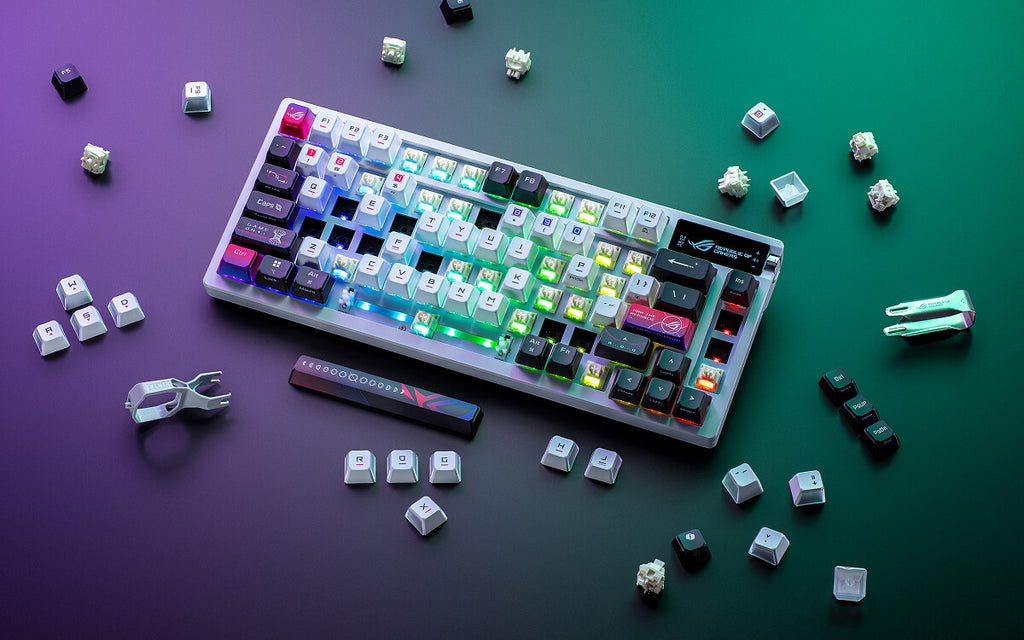 ROG Azoth X with many keycaps and switches removed scattered around the keyboard.
