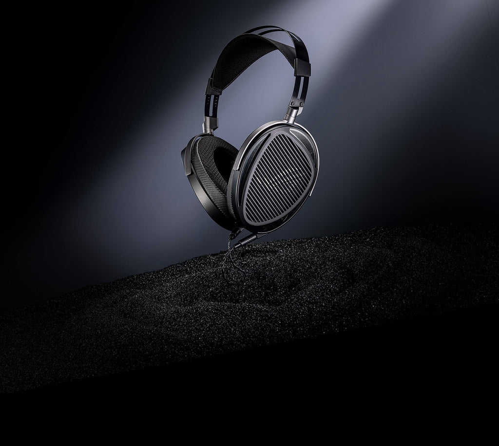 The ROG Kithara open-back gaming headset is showcased against a dark, gradient background, suspended in the background to create a sense of lightness and precision.