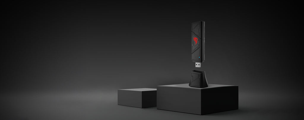 The ROG USB-BE92 adapter is plugging into its cradle.