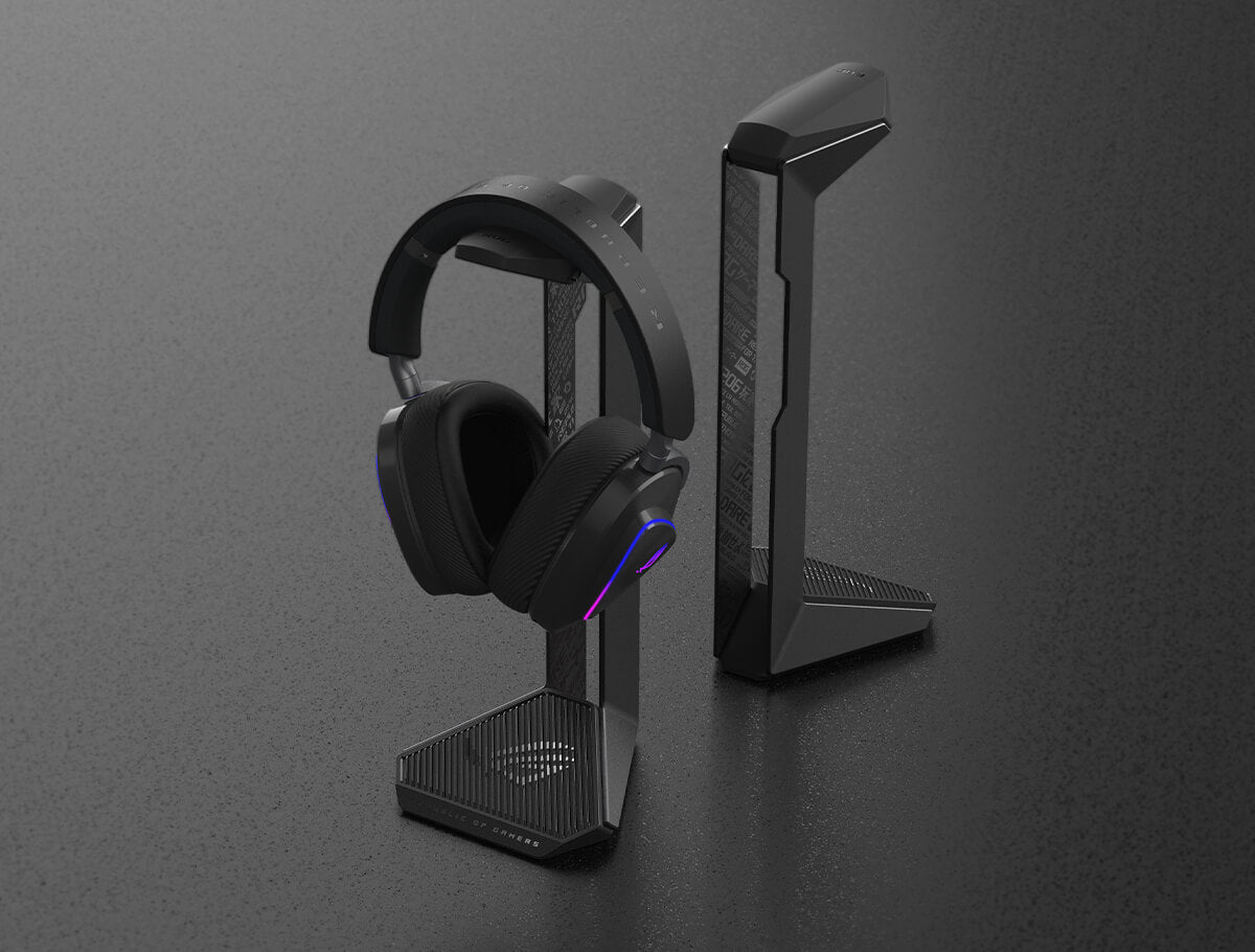 Two ROG Throne II Core Gaming Headsets placed on a grey table, one paired with an ROG Gaming Headset.