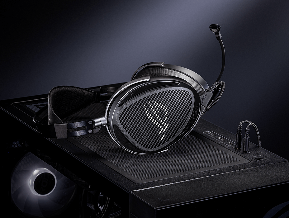 ROG Kithara placed on a PC case and connected via a dual 3.5 mm microphone cable