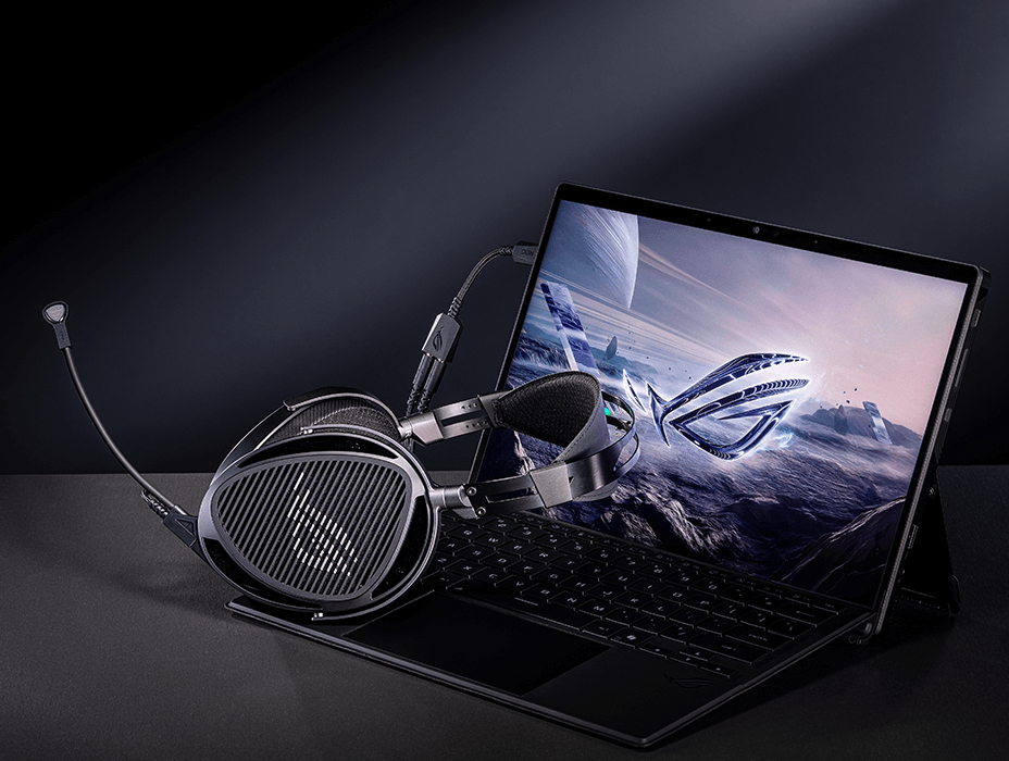 ROG Kithara gaming headset connected to a laptop using a USB-C to dual 3.5 mm adapter