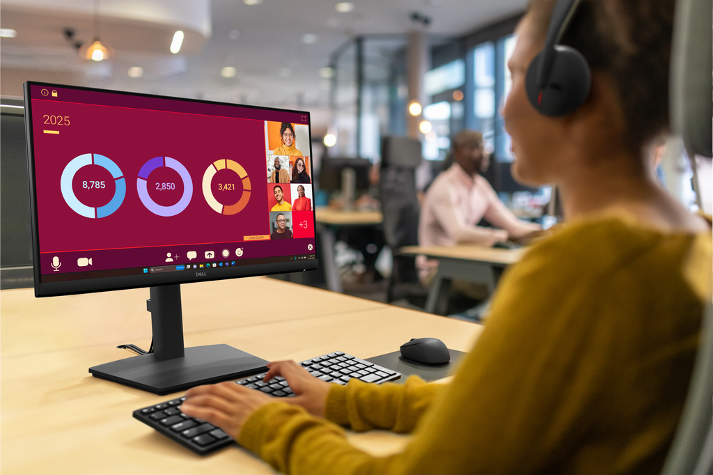 An office worker using a Dell Pro 22 Adjustable Stand Monitor to collaborate during a web conference.