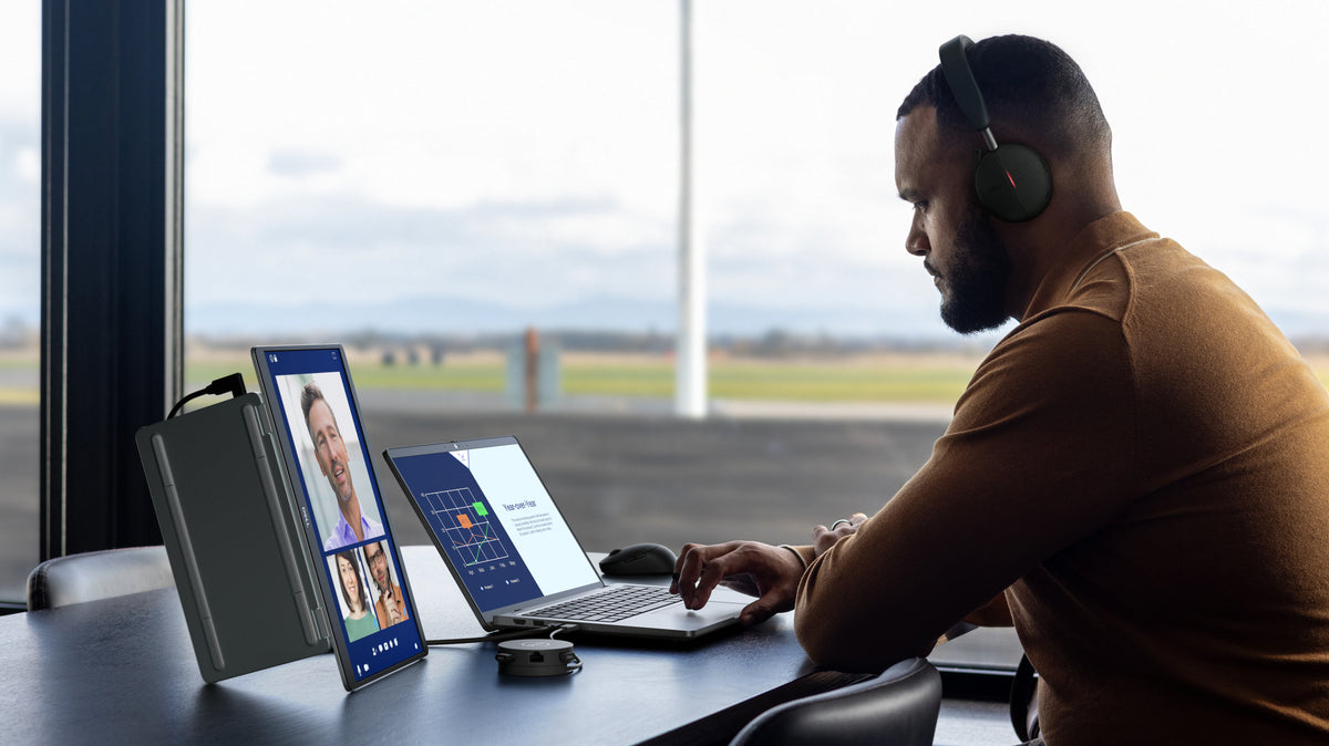 A person working on a Dell Pro 14 plus laptop while on a web conference on an adjacent Dell Pro 14 plus portable monitor.