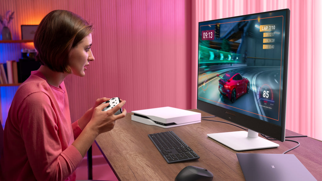 A person gaming with a controller that’s connected to the Dell 32 Plus Monitor via HDMI.