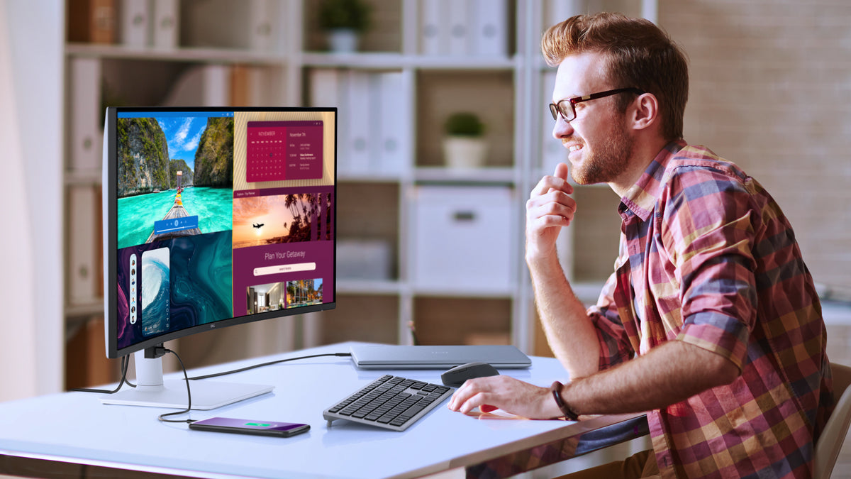 Person using a Dell 34 Plus Monitor with a laptop, keyboard and mouse connected.