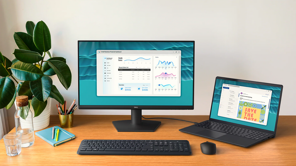 Front facing view of the Dell 24 Monitor on a desk with a laptop connected through an HDMI cord.