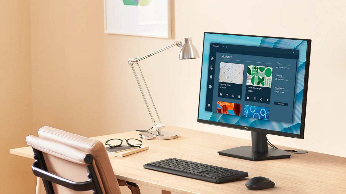 Left facing view of Dell 27 Monitor on a desk with a keyboard and mouse connected.