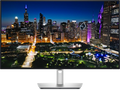 View forward-facing An UltraSharp 32 4K Thunderbolt Hub Monitor with an image of a city skyline.